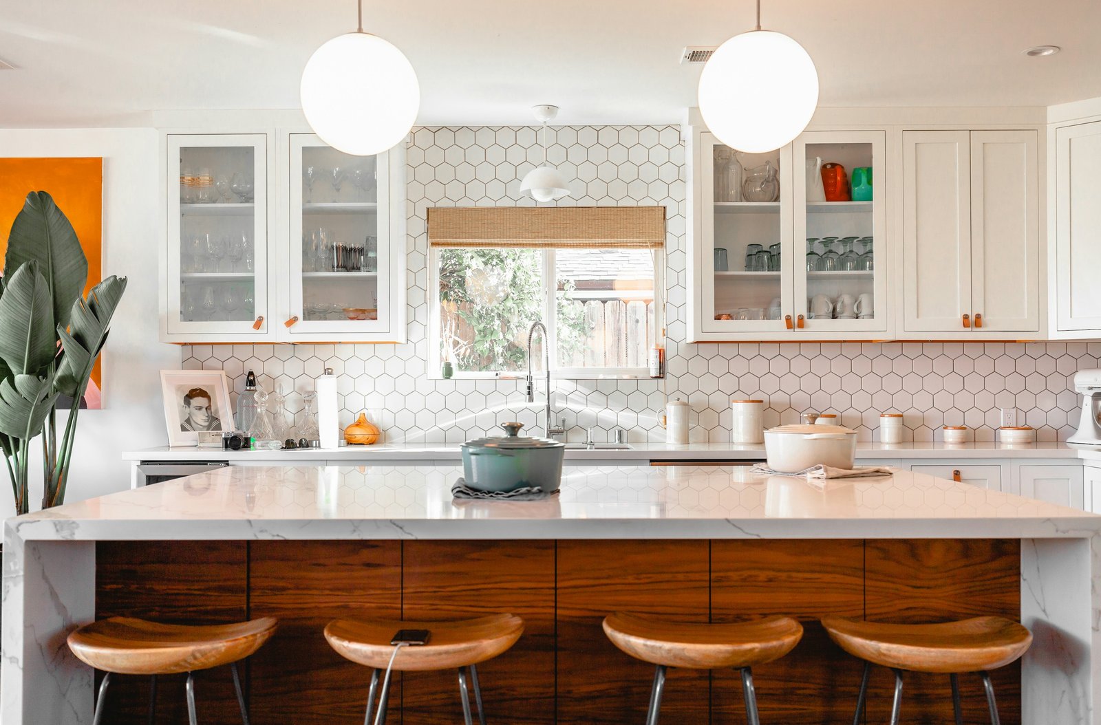Warm wood island with patterned tile backsplash. Stock design inspiration.